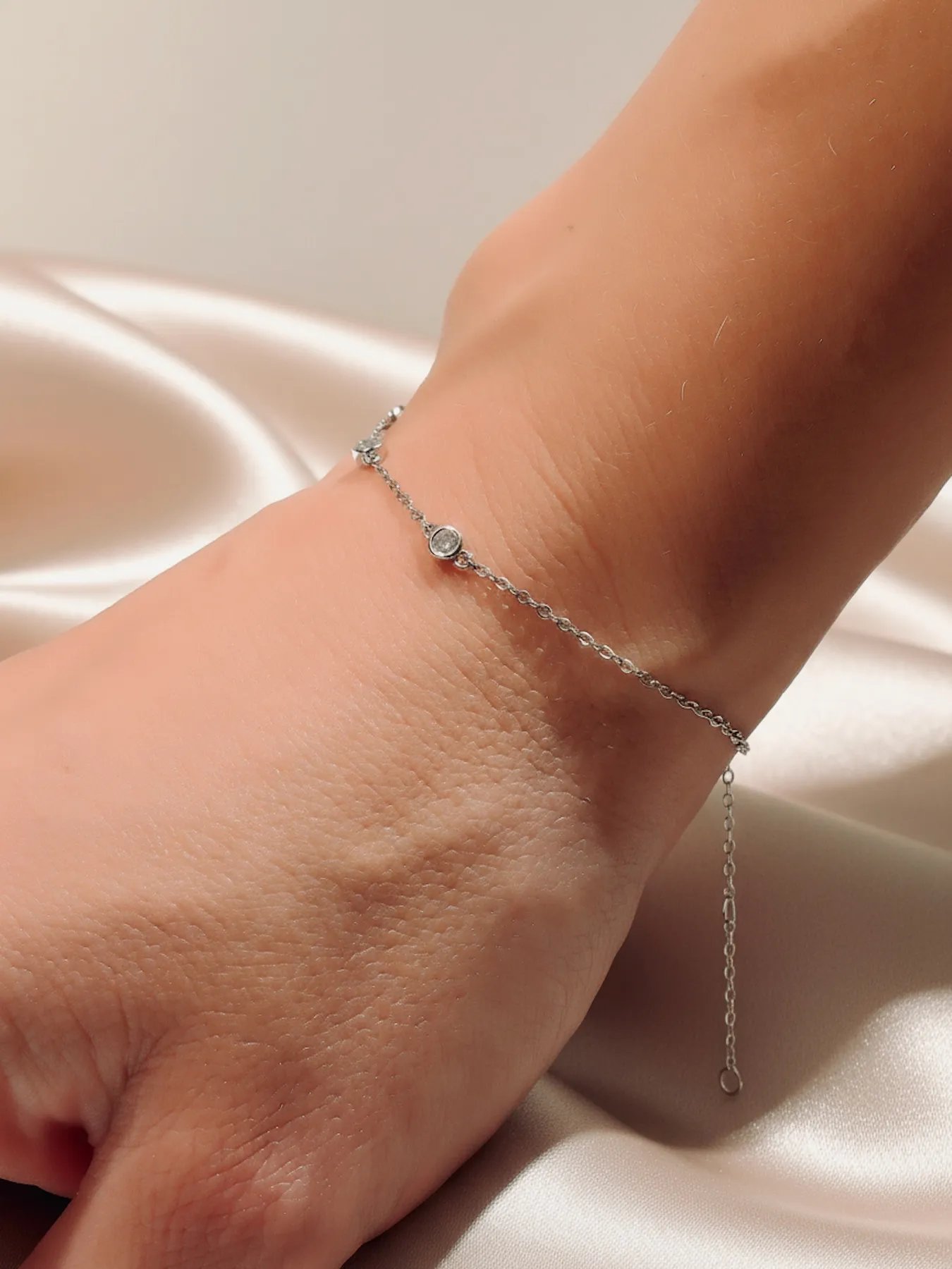 Minimalist silver bracelet with three zircon stones
